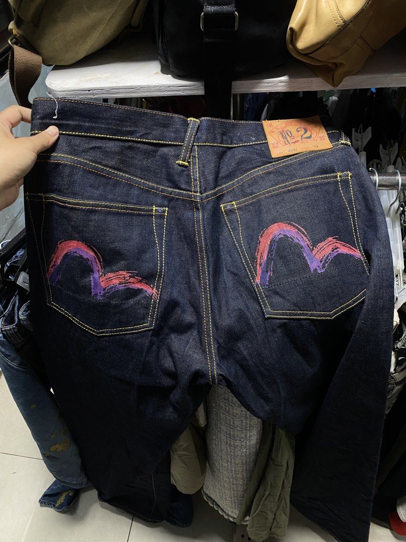 Evisu Selvedge Jeans (Category: Jeans) located in Mangatarem. Submitted by juicybabe_ (Listing ID 1468244846, Image 1). Description: - Size: 32 - Fit: Straight leg cut - Material: 100% cotton - Details: Painted pink and purple gull wings on back pockets, yellow contrast stitching, leather patch on back waistband - Closure: Button fly.