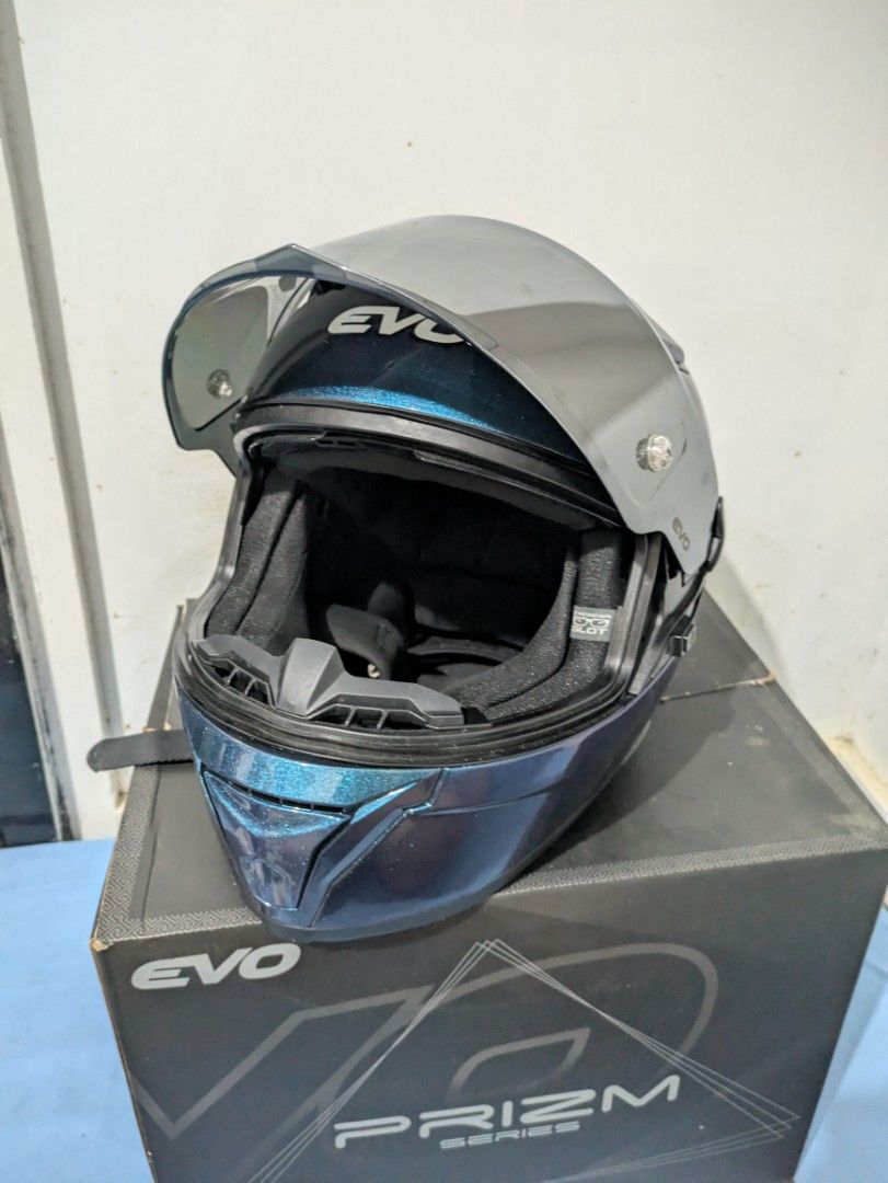 EVO Prizm Series Full Face Helmet (M) (Category: Helmets and other Riding Gears) located in Bocaue. Submitted by _agentorange (Listing ID 1468085278, Image 1). Description: EVO Prizm series motorcycle helmet in Prizm Sapphire finish. Mirrored visor attached, plus an extra clear, anti-scratch visor in the box. Clean interior padding with red trim detail. Quick-release strap buckle. DOT Certified, Dura-flex washable foamset. Aerodynamic vents. ABS 
