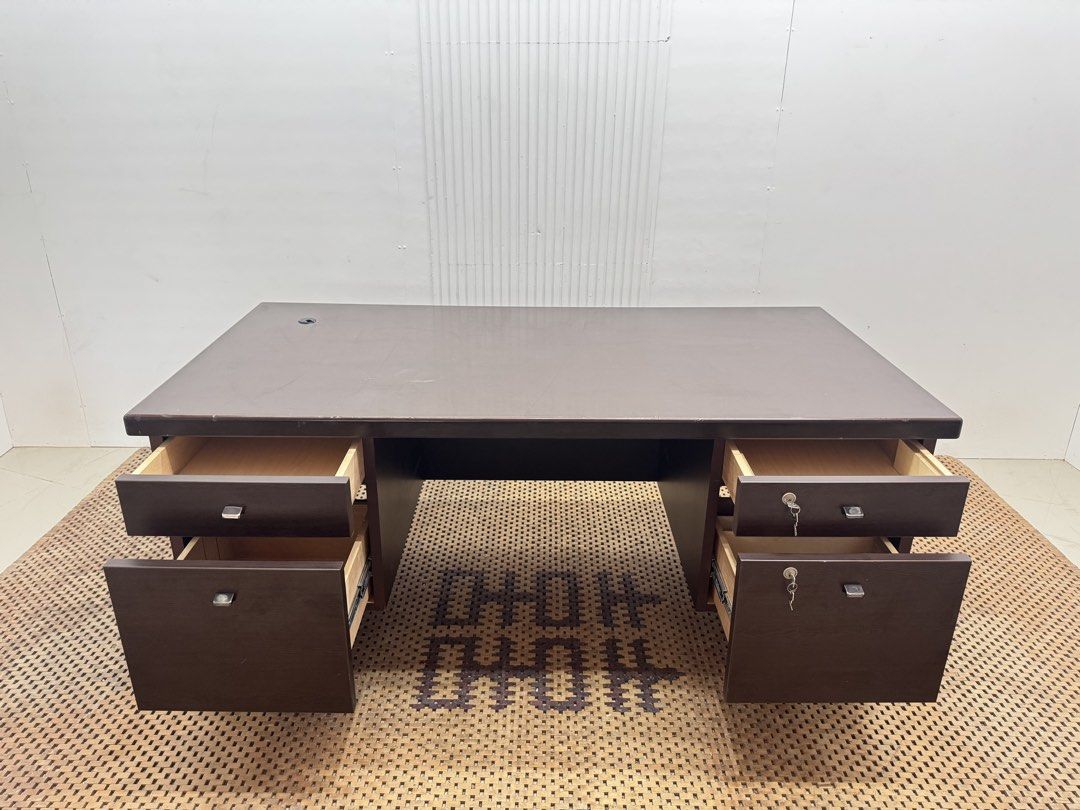 Executive office desk (Category: Tables & Sets) located in Quezon City. Submitted by matetdevis13 (Listing ID 1468229313, Image 3). Description: Dark Brown Executive Office Desk with 4 Drawers & Locks Price: 8,900 L63 x W31.5 x H27.5 In good condition Code JMD38-M497 It features a spacious rectangular tabletop, two side storage pedestals, four drawers, and key locks for secure storage..