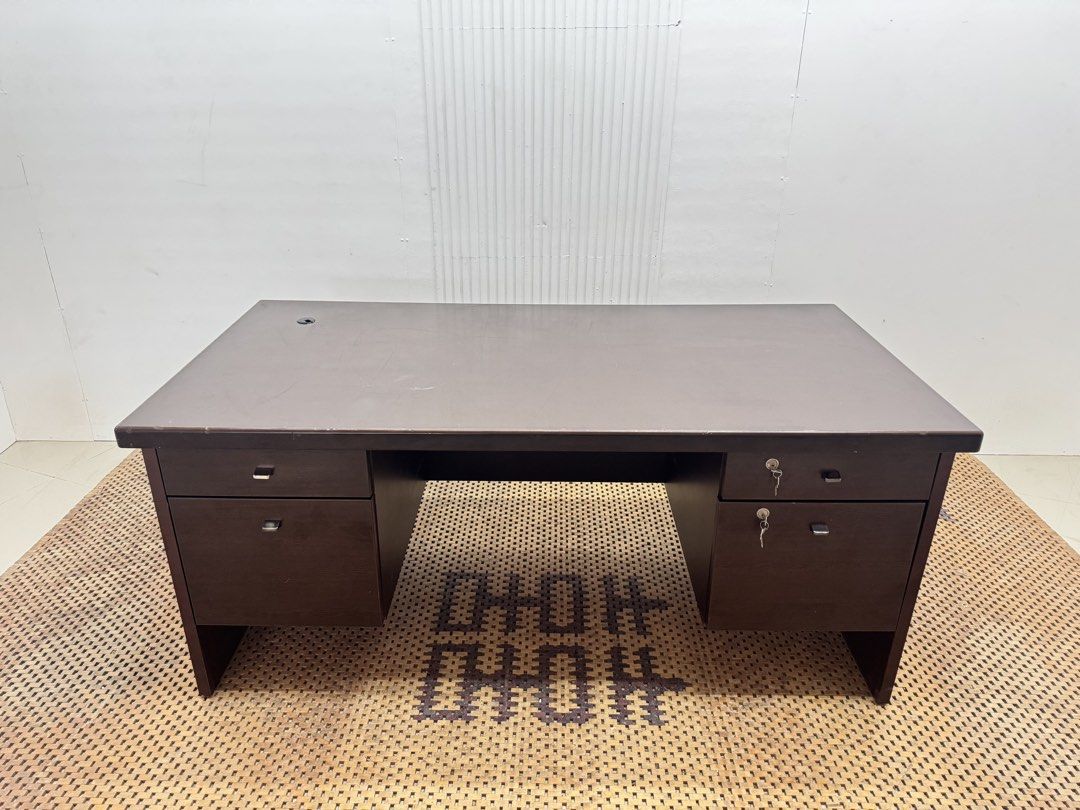 Executive office desk (Category: Tables & Sets) located in Quezon City. Submitted by matetdevis13 (Listing ID 1468229313, Image 2). Description: Dark Brown Executive Office Desk with 4 Drawers & Locks Price: 8,900 L63 x W31.5 x H27.5 In good condition Code JMD38-M497 It features a spacious rectangular tabletop, two side storage pedestals, four drawers, and key locks for secure storage..