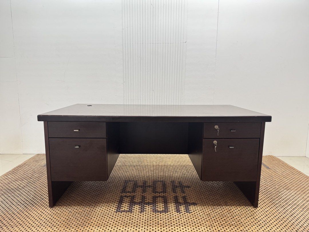 Executive office desk (Category: Tables & Sets) located in Quezon City. Submitted by matetdevis13 (Listing ID 1468229313, Image 1). Description: Dark Brown Executive Office Desk with 4 Drawers & Locks Price: 8,900 L63 x W31.5 x H27.5 In good condition Code JMD38-M497 It features a spacious rectangular tabletop, two side storage pedestals, four drawers, and key locks for secure storage..