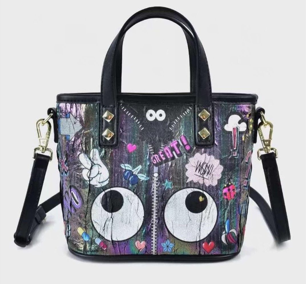 Eye Themed Bag MCM Inspired (Category: Luxury Bags & Wallets) located in Marikina City. Submitted by savemyclosetph (Listing ID 1468241643, Image 1). Description: Eye themed bag, MCM inspired design. Iridescent finish with multi-colored patches, zipper detail down the center, and large cartoon eyes near the bottom. Dual top handles and included adjustable shoulder strap. Protective metal feet on the bottom base. Dimensions measure 23 by 18 by 11 