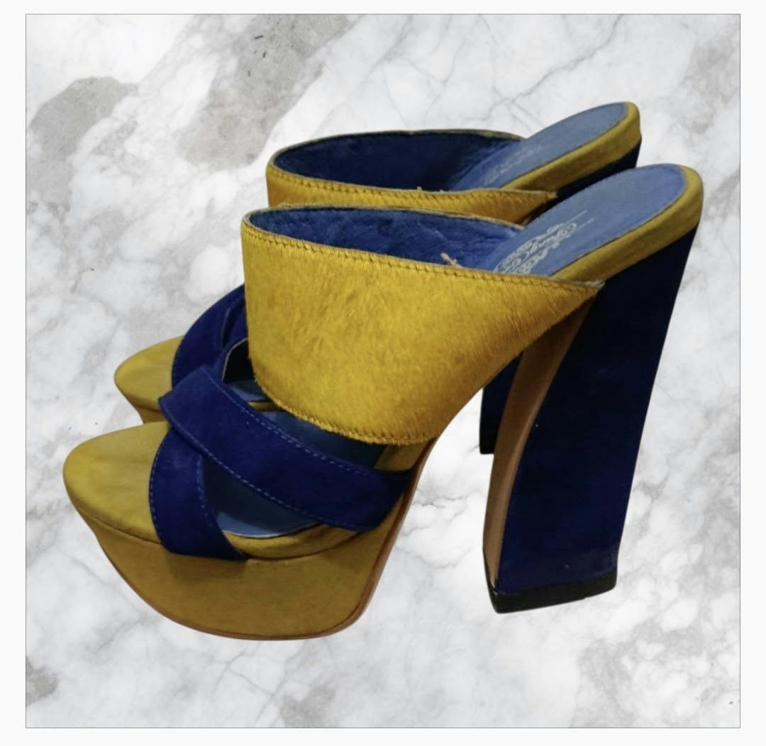 Fang Couture Blue and Yellow Platform Heels (Category: Heels) located in Paranaque City. Submitted by calm_youngstore7 (Listing ID 1468090796, Image 1). Description: - Brand: Fang Couture - Style: Chunky block heel platform sandals - Colorway: Blue and yellow - Materials: Textured yellow upper strap and blue suede crossover straps - Details: Blue branded insole Tang Couture platform mules These shoes are vibrant, color-blocked platform mules feat