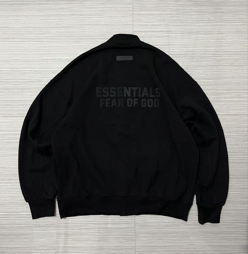 Fear of God Essentials Varsity Jacket / Snap Jacket in black (Category: Coats, Jackets and Outerwear) located in Santa Cruz. Submitted by youngearth.c72f95 (Listing ID 1468059974, Image 1). Description: EXCELLENT CONDITION ISSUE-MISSING 2 BUTTON SEE THE PIC DIMES-26x28 L ON TAG.