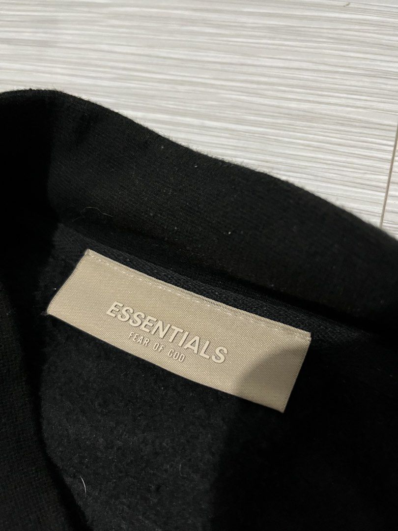Fear of God Essentials Varsity Jacket / Snap Jacket in black (Category: Coats, Jackets and Outerwear) located in Santa Cruz. Submitted by youngearth.c72f95 (Listing ID 1468059974, Image 3). Description: EXCELLENT CONDITION ISSUE-MISSING 2 BUTTON SEE THE PIC DIMES-26x28 L ON TAG.
