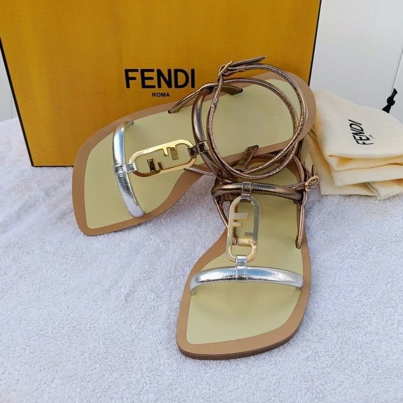 Fendi Flat Sandals Metallic Gold Silver (Category: Flats & Sandals) located in Paranaque City. Submitted by calm_youngstore7 (Listing ID 1468069401, Image 2). Description: - Brand: Fendi - Style: Flat sandals with square toe and ankle wrap buckle closure - Color/Finish: Metallic gold and silver with a pale yellow footbed - Details: Iconic FF hardware logo across the front strap - Inclusion: Complete set with original box, paper shopping bag, and 