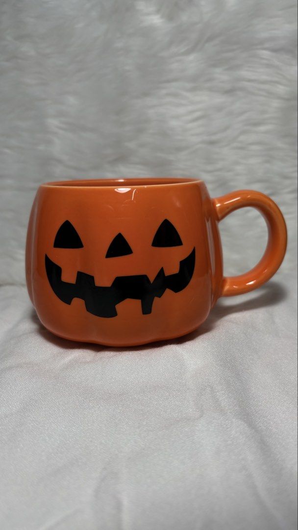 Festive Halloween Pumpkin Jack-O'-Lantern Ceramic Mug (Category: Coffee & Tea Tableware) located in Manila. Submitted by mug.aras (Listing ID 1468221961, Image 1). Description: Get into the spooky spirit with this vibrant pumpkin mug! Features a classic Jack-O’-Lantern face printed on a glossy orange, pumpkin-shaped ceramic body. It is perfect for your morning pumpkin spice latte, Halloween party decorations, or as a fun autumn gift.