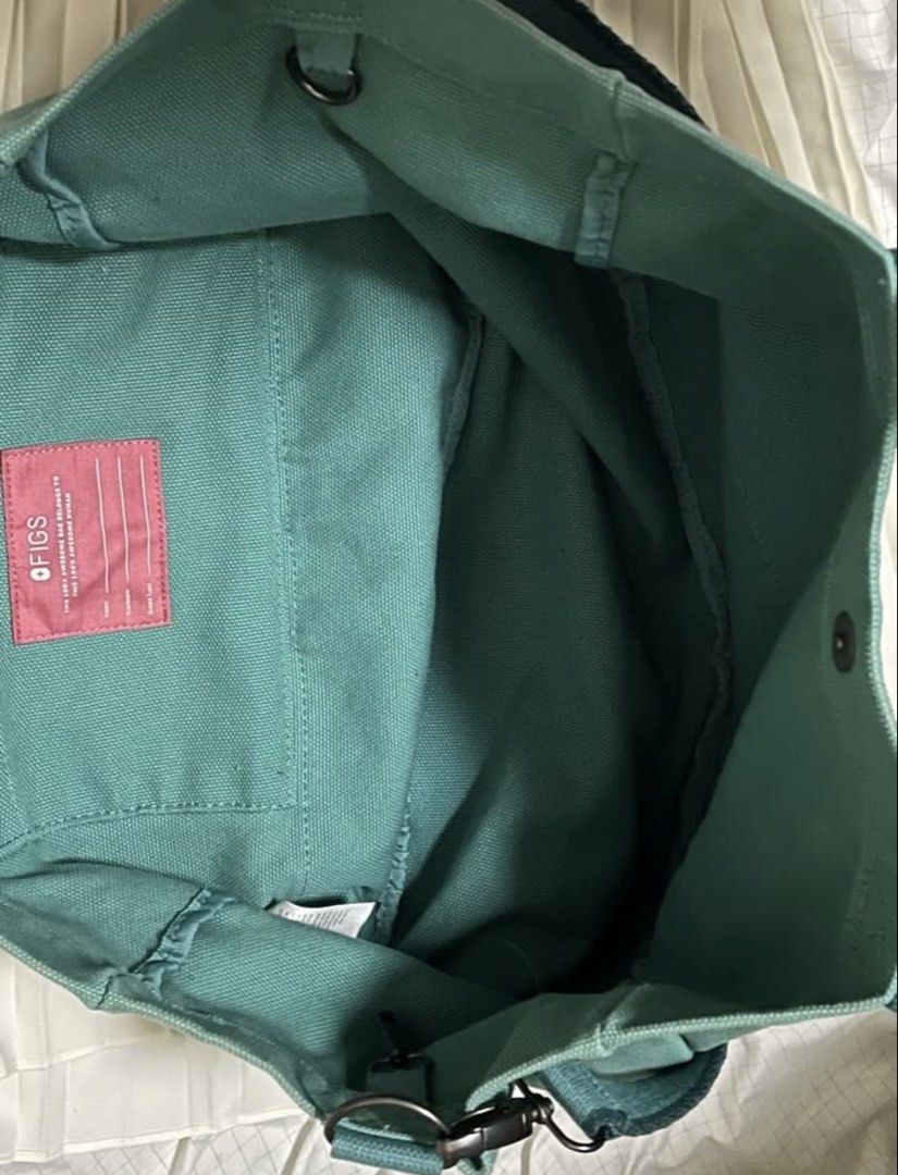 Figs Green Tote Bag (Category: Tote Bags) located in Davao. Submitted by missprelovedbag (Listing ID 1468095856, Image 3). Description: - Authentic Figs green canvas tote bag with bright pink lettering - Versatile carry with double top handles and an adjustable, removable shoulder strap with metal clips - Spacious interior compartment featuring an open slip pocket and a pink ID label tag - Durable, darker green reinforced nylon base panel for ext