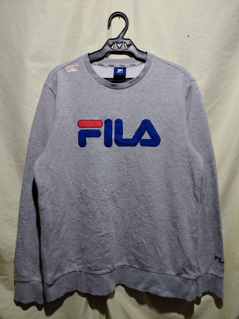 Fila Grey Sweatshirt Size 100 (Category: Coats, Jackets and Outerwear) located in Caloocan City. Submitted by vincefresn21903 (Listing ID 1468281766, Image 1). Description: - Authentic Fila grey sweatshirt - Bold embroidered logo across the chest - Signature Fila branding on the left sleeve cuff - Comfortable ribbed collar, cuffs, and hem - Size tag: 100 - Features stylish repeating Fila text on the inside neck tape.