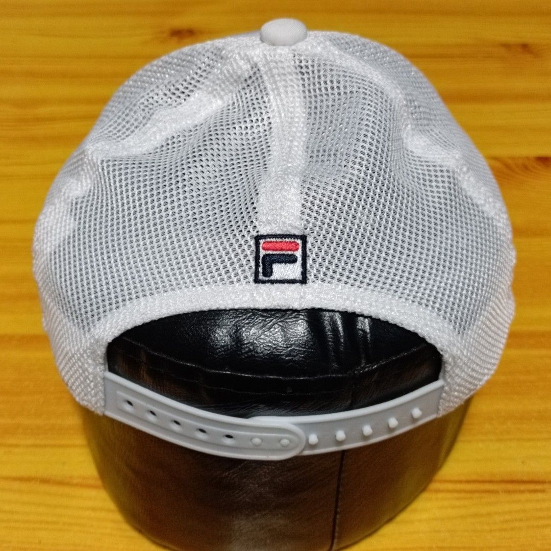 FILA White Mesh Tropical Print Snapback Cap (Category: Caps & Hats) located in Manila. Submitted by caps08 (Listing ID 1468257649, Image 3). Description: - Brand: FILA - Color: White with tropical leaf print and light blue brim stripes - Design: Mesh back panels for breathability, large FILA front logo, and small embroidered logo at the back - Fit: Adjustable plastic snapback closure (Size: 52-54cm) - Style Code: K18B022223F - Condition: Brand ne