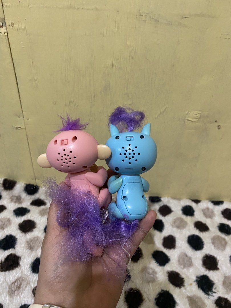 Fingerlings interactive monkey and unicorn toys (Category: Interactive Toys) located in Baguio. Submitted by thrift_bonita (Listing ID 1468203378, Image 2). Description: - Set of 2 interactive Fingerlings figures (Pink Monkey and Blue Unicorn) - Adorable purple fuzzy hair on both figures - Features built-in speakers and power switches on the back of the head - Easy-access battery compartments underneath - Fun and engaging toys for kids - Selling 