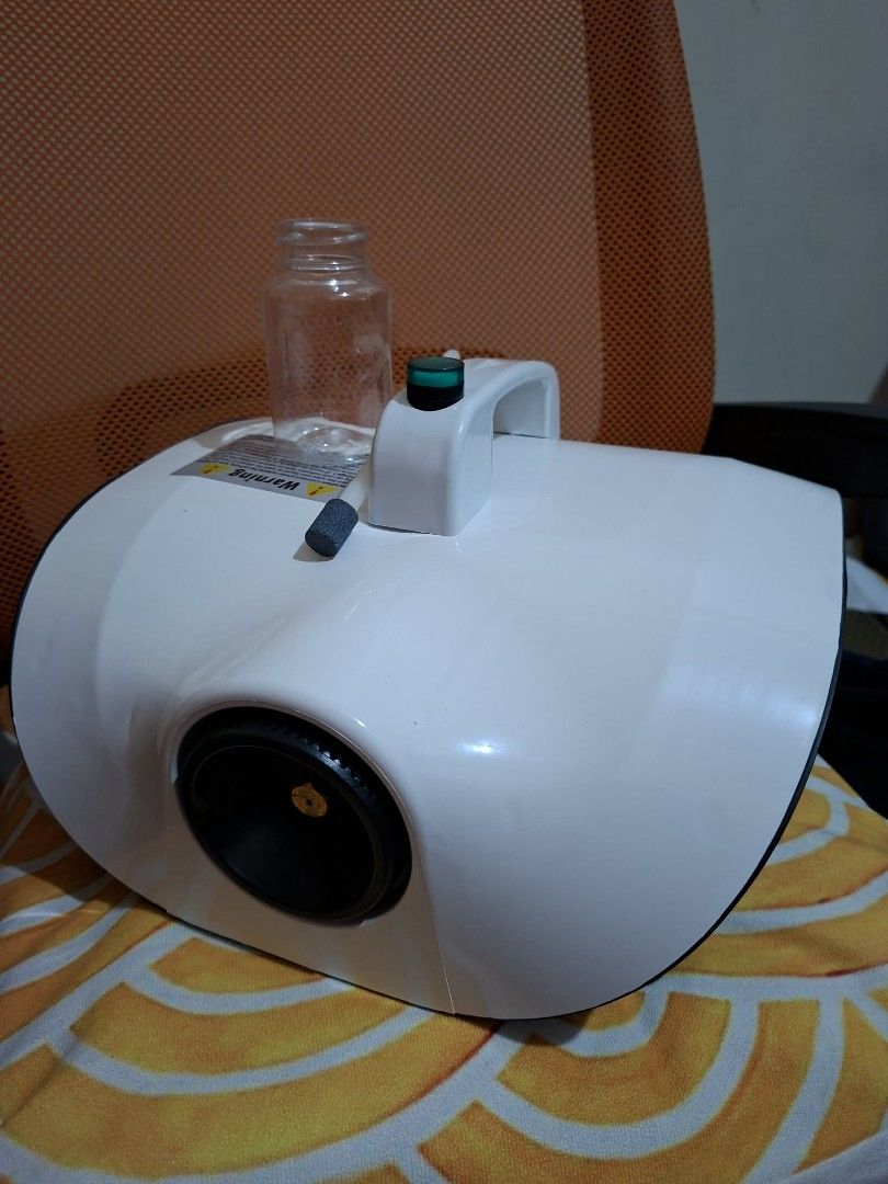 Fog Machine Disinfectant Spritzer with Fogging Solution (Shangrila) (Category: Cleaning Tools & Supplies) located in Pasig City. Submitted by kimpr (Listing ID 1468251523, Image 2). Description: - Color: Sleek white - Condition: Great working condition with original box included - Features: Adjustable output control dial, clear liquid container, and feed tube - Power: Attached power cord for easy plug-and-play use - Best For: Fast and efficient s