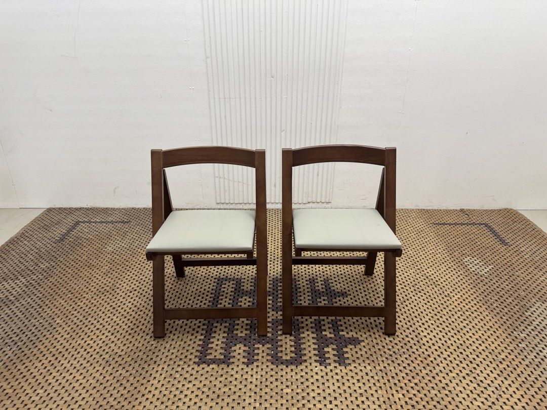 Folding chair (Category: Chairs) located in Quezon City. Submitted by matetdevis13 (Listing ID 1468231123, Image 2). Description: NEW! VIVI CASA Set of 2 Brown Wooden Folding Dining Chairs with Cream Cushioned Seats Price: 4,900 L17.5 x W18 x H27/17.5 Brand New with box Code JMD15-M117A They feature a warm brown wooden frame, cream padded seats, curved backrests, and a foldable design for easy storage..