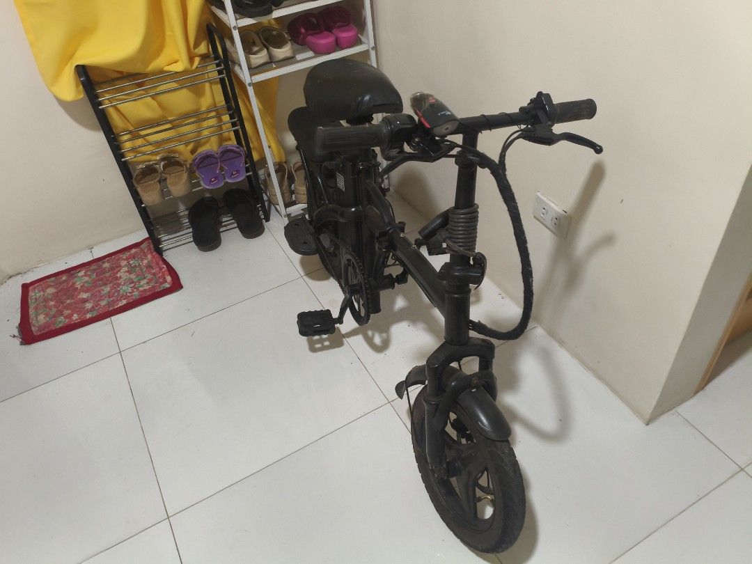 folding e bike (Category: Bicycles) located in Marikina City. Submitted by whatxdxfudge (Listing ID 1467283272, Image 2). Description: - Color: Black - Type: Compact folding bike with small wheels - Extras: Main saddle plus an extra small rear seat - Portability: Folding pedals and collapsible handlebar stem for easy storage - Safety: Chain guard attached - Condition: Battery Not Charging -RFS: Need funds.