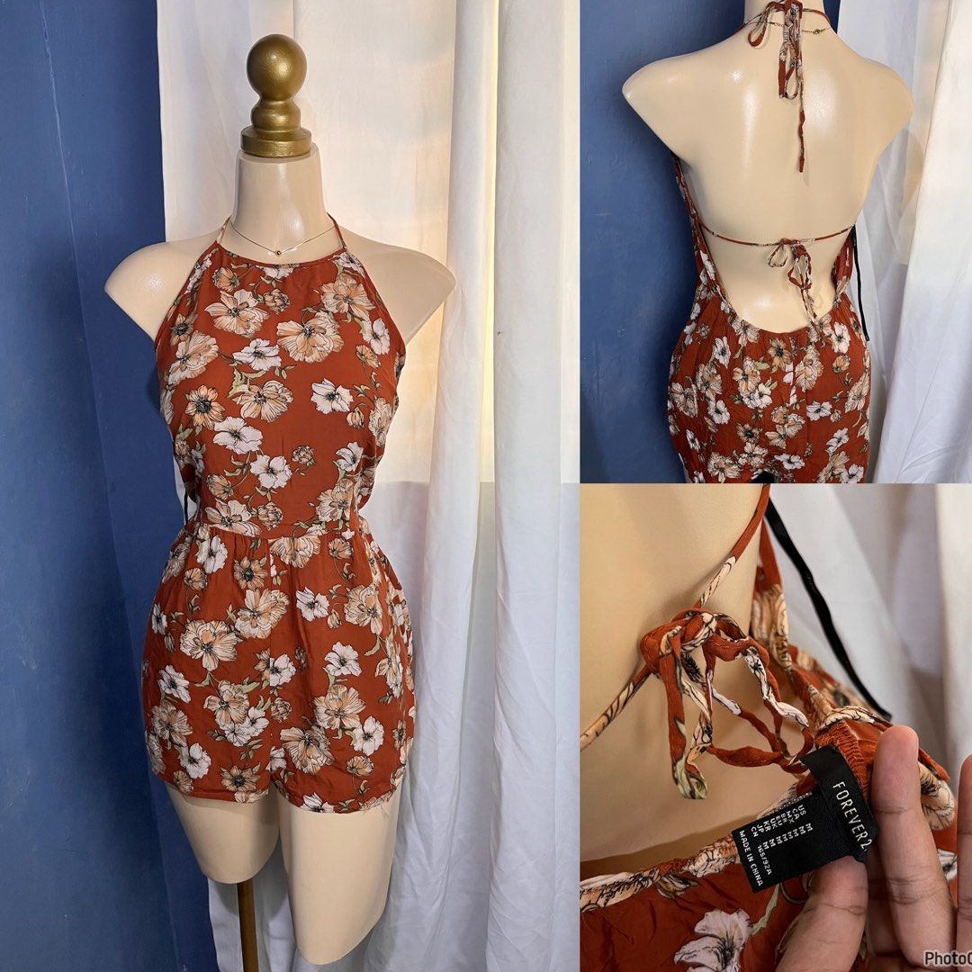 Forever 21 Floral Print Halter Neck Romper (Category: Rompers) located in Valencia. Submitted by kathrift (Listing ID 1468159421, Image 1). Description: - Brand: Forever 21 - Size: Medium - Color/Pattern: Rust orange with white and cream floral print - Style: Halter neck with tie straps, open back, and elastic waistband - Fabric: Super lightweight, ideal for warm weather - Condition: Great pre-loved condition / Brand new (ready to wear!).