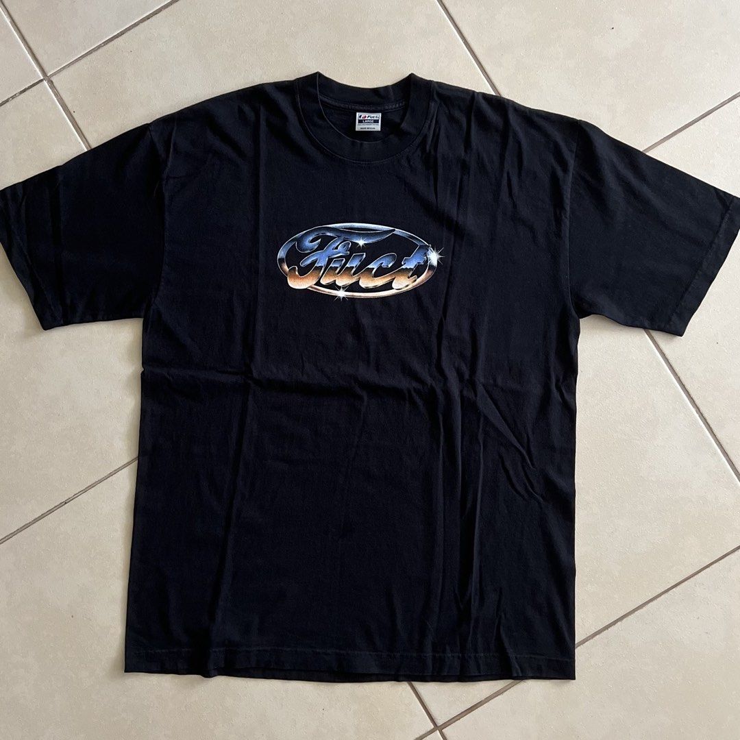 FUCT Chrome T-Shirt L (Category: Tshirts & Polo Shirts ) located in Taguig. Submitted by groovez_jp (Listing ID 1468096664, Image 2). Description: - Brand: FUCT - Color: Black - Size: Large (Classic fit) - Design: Chrome Ford-style logo with sparkle accents across the chest - Material: 100% pre-shrunk heavyweight cotton - Origin: Made in U.S.A. - Condition: Clean, no holes, no stains.