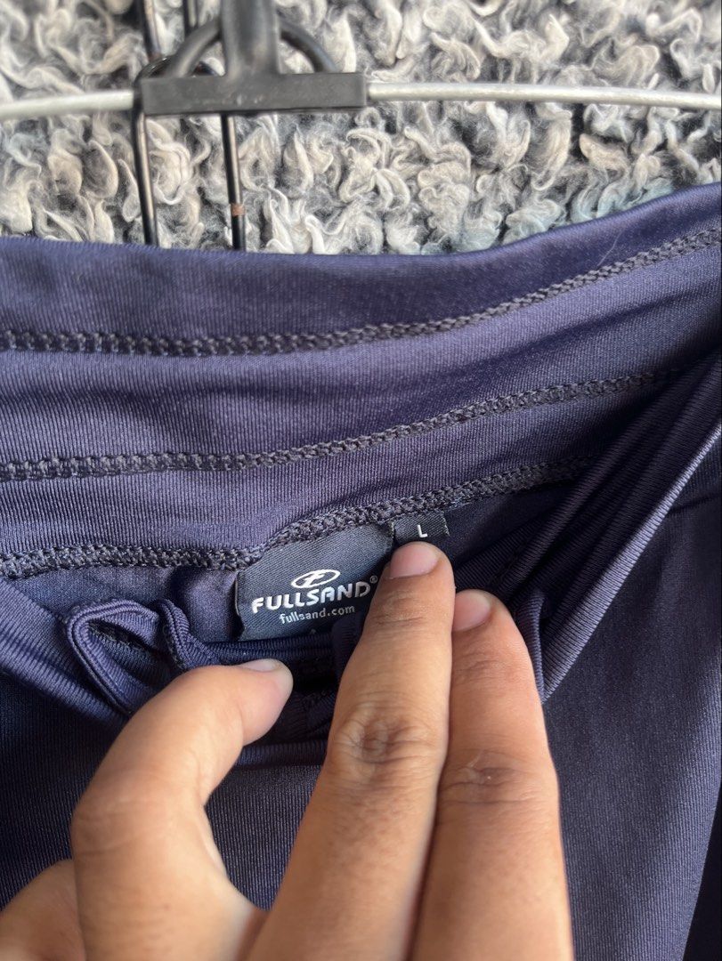 Full Sand navy blue athletic skort | Size L (Category: Skirts) located in General Trias. Submitted by zrchustle.604 (Listing ID 1468281521, Image 3). Description: Full Sand navy blue athletic skort branded with the logo for Xcaret Xailing, which is an official ferry and catamaran excursion service based in Cancun, Mexico. This garment features an overlapping faux-wrap skirt overlay with a rounded dolphin-style hem and an elastic waistband..