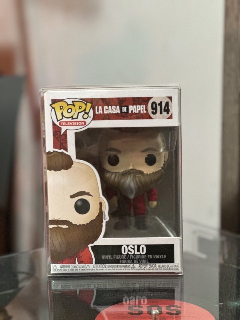 Funko Pop Television La Casa De Papel Oslo (Category: Designer & Blind Box Toys) located in General Trias. Submitted by marbyndln (Listing ID 1468267021, Image 1). Description: - Item: Funko Pop La Casa De Papel - Oslo (#914) - Condition: Mint, with clean window and sharp corners - Protection: Includes original box inside a clear protective plastic case - Storage: Carefully stored away from direct sunlight - Ideal for: Money Heist fans and seriou