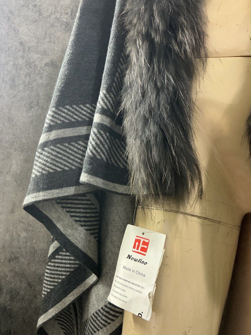 Fur collar large poncho (Category: Coats, Jackets and Outerwear) located in Angeles City. Submitted by goodbuysathome (Listing ID 1468246023, Image 2). Description: gray and black plaid/patterned shawl or poncho cape with a contrasting dark faux or real fur collar (such as the Modena Faux Fur Plaid Poncho or similar styles by brands like Jayley or Gucci). 60x36 inches brand-new Lp posted Add Sf 55 .