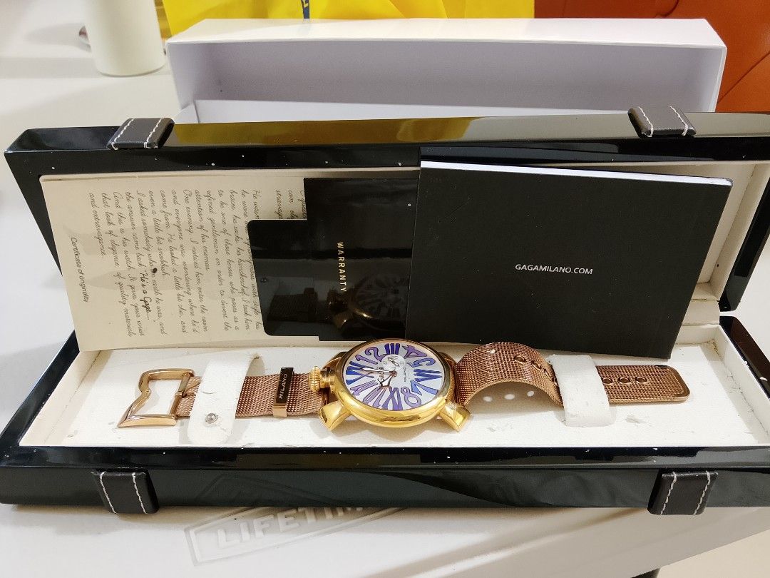 GaGa Milano Watch Box Set (Category: Women's Watches) located in Paranaque City. Submitted by paras0620 (Listing ID 1468111506, Image 1). Description: - Authentic GaGa Milano glossy black watch box - Features a sleek gold logo stamped in the center - Designed with decorative leather straps and metal buckles on both ends - Includes the original white outer cardboard box - Ideal for watch storage, display, or gifting issue: Hairliness.