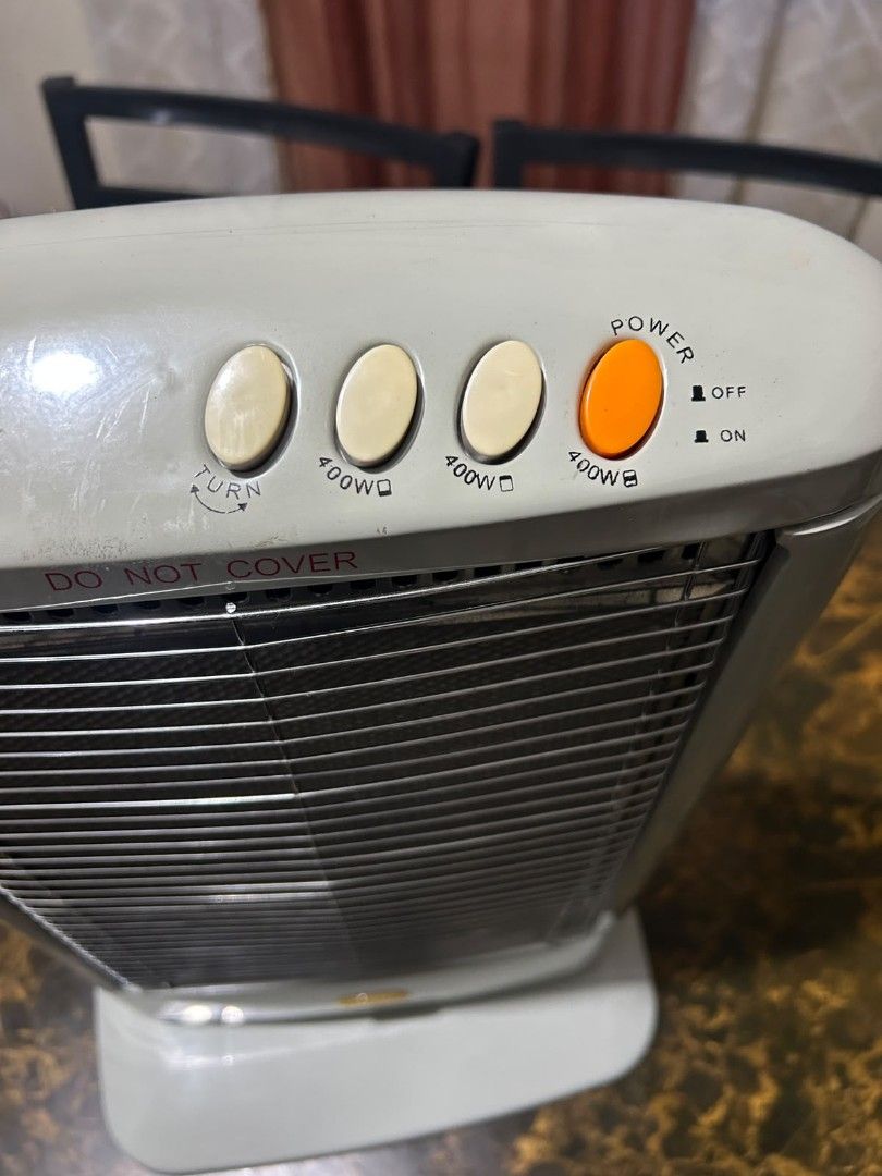 Galileo electric heater (Category: Electrical, Adaptors & Sockets) located in Taguig. Submitted by lhadychinitah (Listing ID 1468255686, Image 1). Description: Type: Halogen Infrared Heater. Power Output: 1200W. Controls: Three buttons on top likely for heat settings. Safety Features: Includes a protective front grill and rotary controls for adjustable heating..