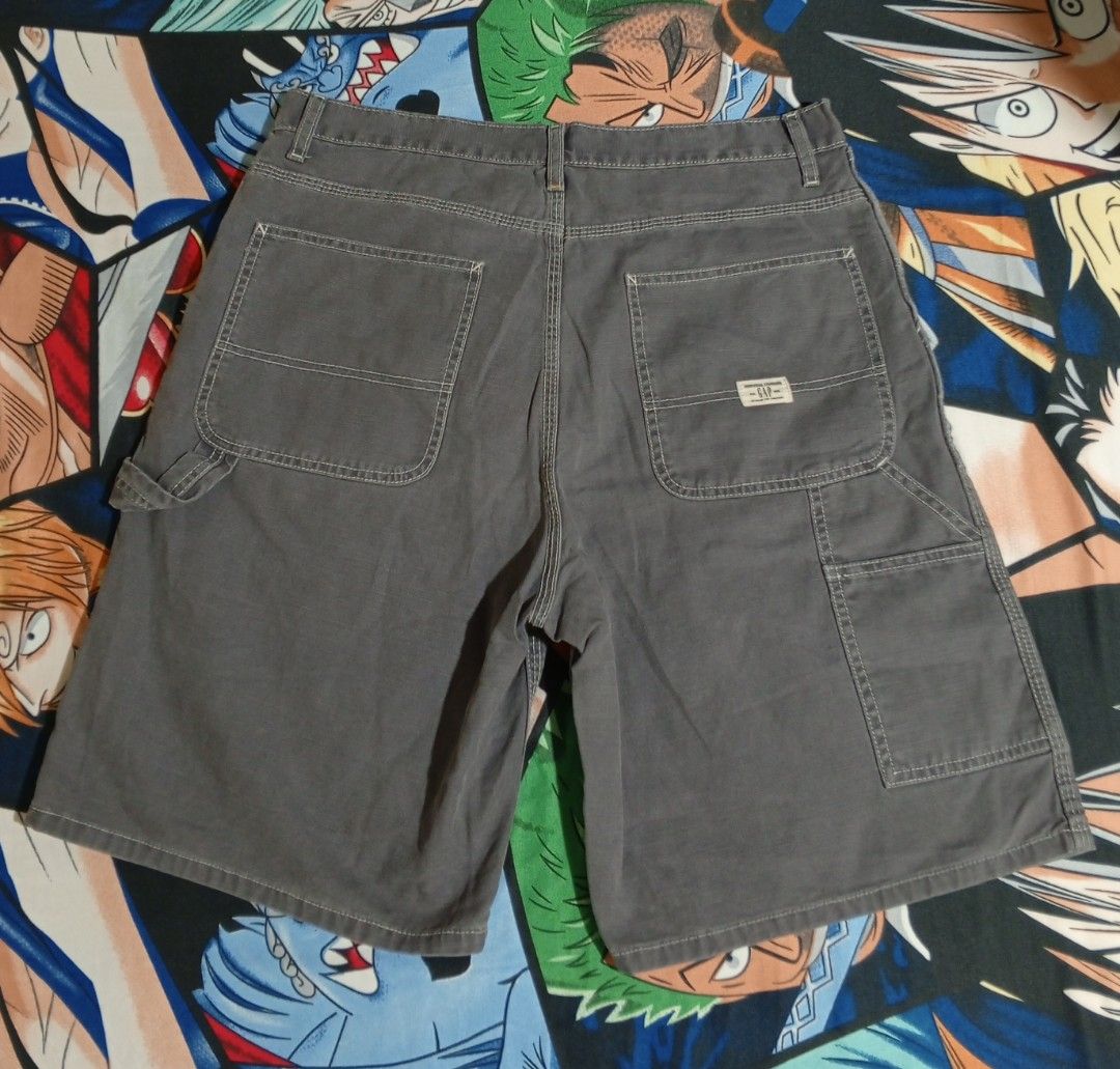 Gap Carpenter Shorts Size 36 (Category: Shorts) located in Castillejos. Submitted by eross07 (Listing ID 1468200721, Image 3). Description: - Brand: Gap Factory Store - Style: Utility cargo shorts with straight leg fit - Color: Dark grey - Size: 36 - Material: 100% cotton - Features: Tool pockets, hammer loop, contrast stitching, and branded metal button closure.