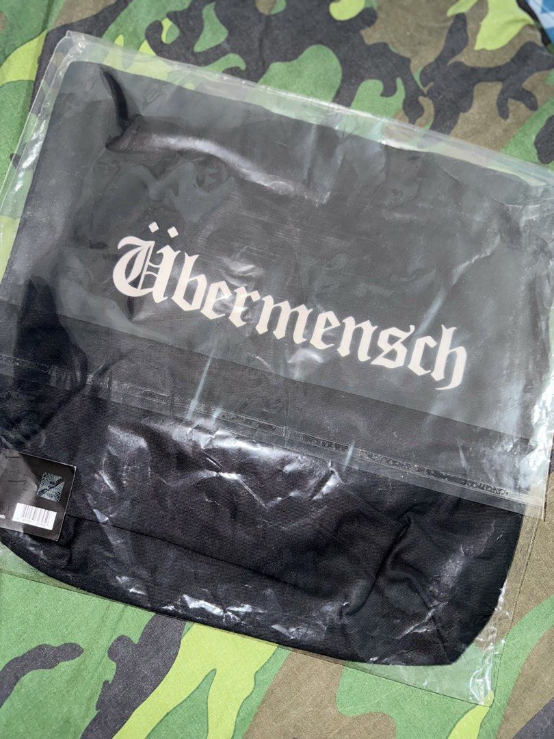 G-DRAGON UBERMENSCH Black Eco Bag (Category: Music Accessories) located in Manila. Submitted by trumanblack1975 (Listing ID 1468176951, Image 1). Description: - G-DRAGON UBERMENSCH (Made in Korea by Galaxy Corp & Copan Global) - Condition: Brand new, unopened, sealed in original plastic packaging with tag attached - Material: Black cotton - Size: 400 x 400 x 100 mm - Design: Large gothic logo on the front, graphic symbol on the back.