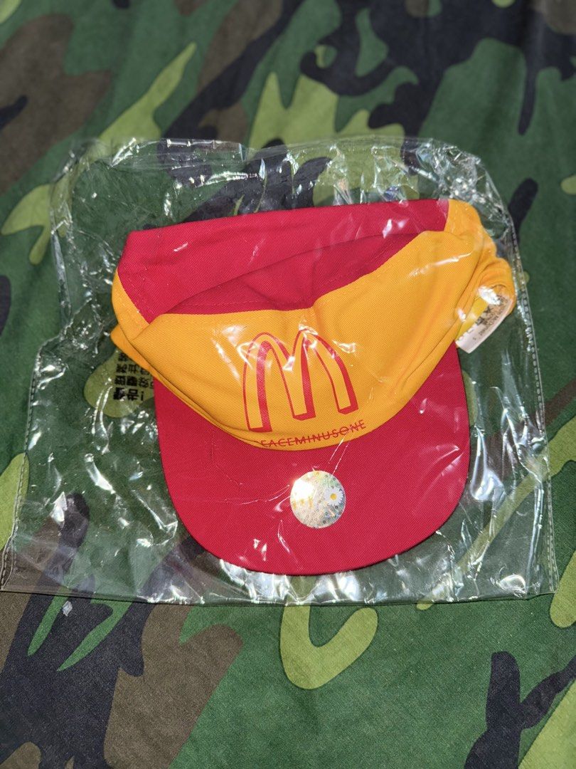 G-DRAGON McDonald's x Peaceminusone Cap (Category: Music Accessories) located in Manila. Submitted by trumanblack1975 (Listing ID 1468176267, Image 1). Description: - Item: G-DRAGON McDonald's x Peaceminusone Collaboration Cap - Colorway: Red and yellow - Design: McDonald's golden arches and Peaceminusone branding on the front - Detail: Signature daisy flower on the back strap - Condition: Brand new, still sealed inside the original plastic packa