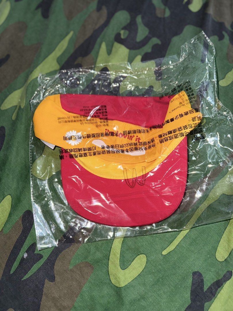 G-DRAGON McDonald's x Peaceminusone Cap (Category: Music Accessories) located in Manila. Submitted by trumanblack1975 (Listing ID 1468176267, Image 2). Description: - Item: G-DRAGON McDonald's x Peaceminusone Collaboration Cap - Colorway: Red and yellow - Design: McDonald's golden arches and Peaceminusone branding on the front - Detail: Signature daisy flower on the back strap - Condition: Brand new, still sealed inside the original plastic packa