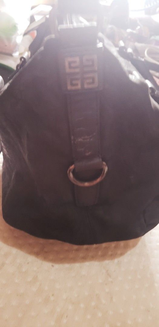 Givenchy Black Leather Handbag (Category: Luxury Bags & Wallets) located in Marikina City. Submitted by racoon143 (Listing ID 1468104626, Image 3). Description: Black leather handbag with top handles and Givenchy 4G logo hardware on the side strap details. Zip top closure across the main compartment. Soft textured leather finish with silver-toned hardware rings. Roomy everyday shoulder bag style..