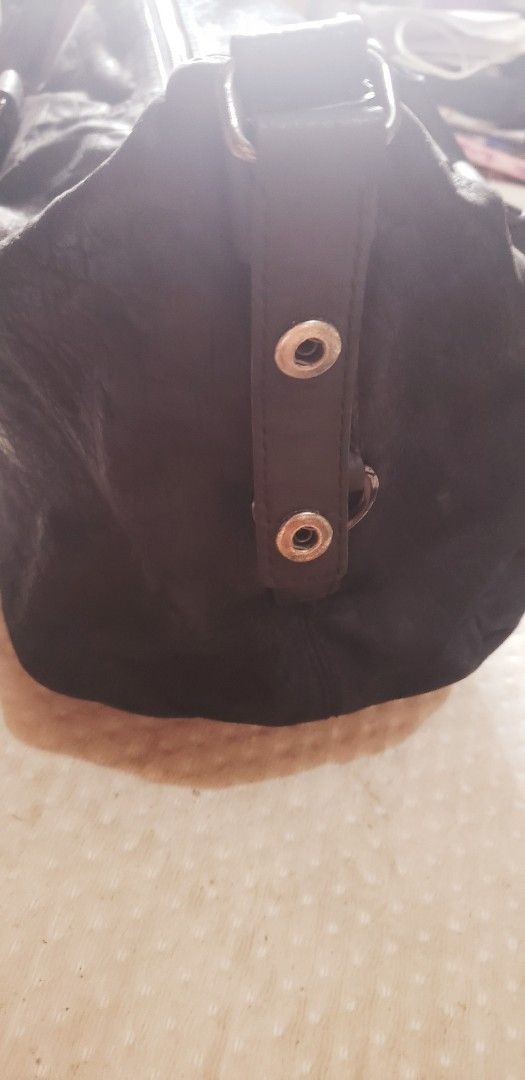 Givenchy Black Leather Handbag (Category: Luxury Bags & Wallets) located in Marikina City. Submitted by racoon143 (Listing ID 1468104626, Image 2). Description: Black leather handbag with top handles and Givenchy 4G logo hardware on the side strap details. Zip top closure across the main compartment. Soft textured leather finish with silver-toned hardware rings. Roomy everyday shoulder bag style..