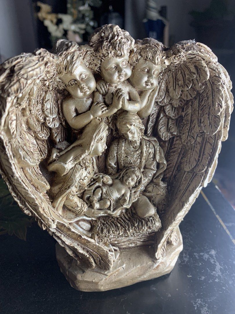 Gold Nativity Scene Figurine with Angels (Category: Figurines & Statues) located in Quezon City. Submitted by sojisup (Listing ID 1468068188, Image 3). Description: - Gold-toned nativity scene figurine - Features Mary, Joseph, and baby Jesus - Surrounded by three cherub angels with detailed wing carvings - Stands on a solid base with a back support stand.
