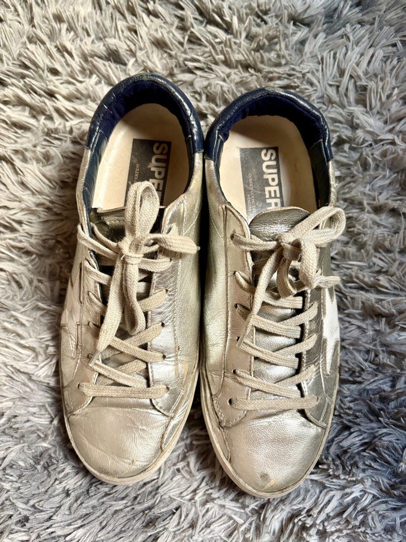 GOLDEN GOOSE superstar (Category: Sneakers & Footwear) located in Manila. Submitted by jlj_v.2_oshop (Listing ID 1468121996, Image 1). Description: Original GG Super-Star metallic silver leather low-top sneakers with a contrasting navy blue heel tab featuring the brand’s signature distressed leather finish, and white star patch. .