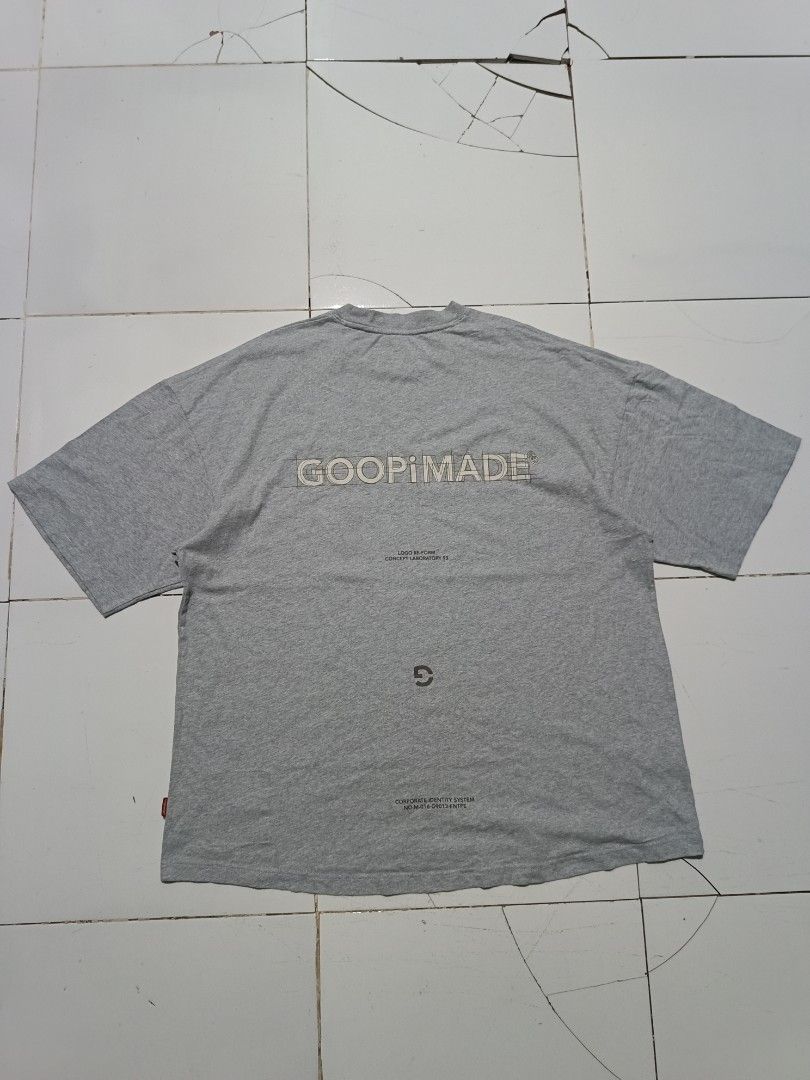 GOOPiMADE Grey Graphic Tee (Category: Tshirts & Polo Shirts ) located in Barotac Nuevo. Submitted by gray101 (Listing ID 1468208983, Image 1). Description: - Brand: GOOPiMADE - Color: Grey - Fit: Relaxed fit for daily comfort - Material: Premium soft cotton fabric with a clean neckline - Details: Small GMUC text print on chest - Back Design: Large schematic logo with concept laboratory text - Accent: Signature red branded tag on the lower hem - P