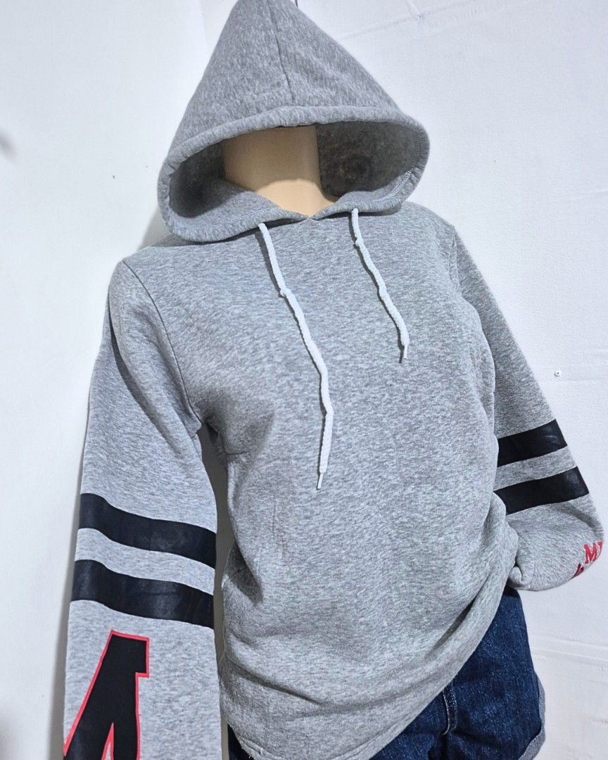 Gray Varsity Letter Hoodie | M-L | Comfy Casual Pullover (Category: Hoodies) located in Cabanatuan. Submitted by _erboutique (Listing ID 1468255586, Image 2). Description: • Heather gray pullover hoodie — varsity style sleeve stripes & letter detail • Soft fleece fabric, adjustable white drawstring hood • Relaxed fit — perfect for everyday wear • Size: M–L | Shoulder: 17" | Bust: 40" | Length: 25" • Code: H1067 • Great preloved condition.