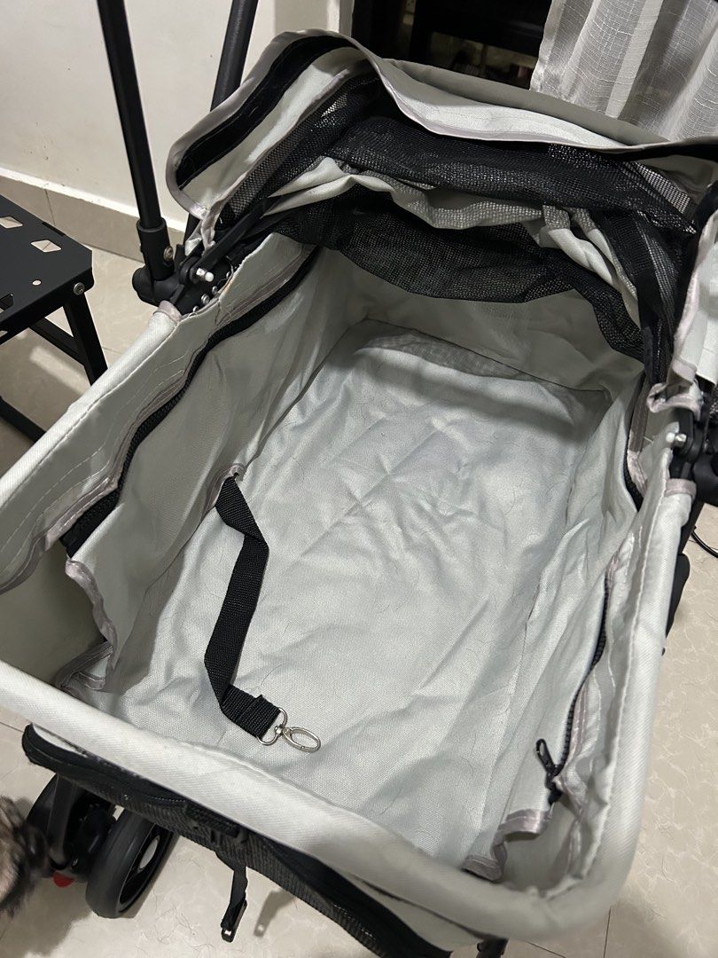 Grey Foldable Pet Stroller with Cup Holder and Storage (Category: Strollers) located in Mandaluyong City. Submitted by ncooooooo (Listing ID 1468224261, Image 2). Description: RFS: Changed to a bigger cart. Naka tambak lang but no issues aside from the foam cracks on the carrier bar due to sun exposure. Minimal wear, visible on the wheels. Already washed the liner. - Color: Grey - Condition: Good working condition, minor surface cracking and wear