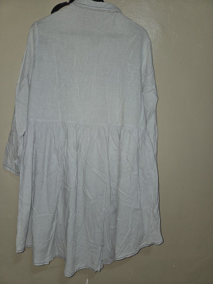 Grey Long Sleeve Button Down Dress (Category: Dresses) located in Quezon City. Submitted by klarebear15 (Listing ID 1468237946, Image 3). Description: - Brand: Cloth Scenery - Size: S but fits Large - Color: Grey - Design: Button-down front with collar, tiered skirt, and long sleeves with button cuffs - Material: Lightweight with visible stitching details - Style: Casual daily wear, easy to match with sneakers or flats.