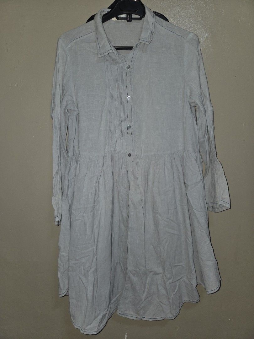 Grey Long Sleeve Button Down Dress (Category: Dresses) located in Quezon City. Submitted by klarebear15 (Listing ID 1468237946, Image 1). Description: - Brand: Cloth Scenery - Size: S but fits Large - Color: Grey - Design: Button-down front with collar, tiered skirt, and long sleeves with button cuffs - Material: Lightweight with visible stitching details - Style: Casual daily wear, easy to match with sneakers or flats.