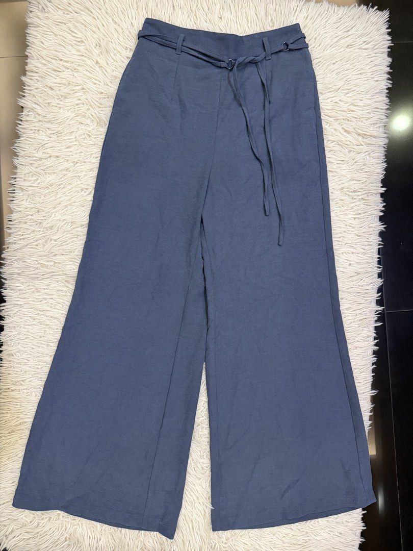 GU Blue Wide Leg Pants Size XL (Category: Jeans) located in Manila. Submitted by kristinata44809 (Listing ID 1468207254, Image 1). Description: - Brand: GU - Style: High-waisted wide leg pants with matching fabric belt - Color: Muted blue - Size: XL (elastic back waistband for extra comfort) - Material: Lightweight textured fabric - Condition: Clean, well-maintained, and ready to wear.