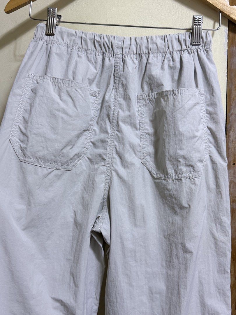 GU Light Grey Nylon Pants Size S (Category: Other Bottoms) located in Paete. Submitted by skydruemadison (Listing ID 1468194035, Image 3). Description: - Brand/Model: GU nylon pants - Color: Light grey - Size: S (fits waist 59-63cm) - Waistband: Elastic with adjustable drawstring - Pockets: Multiple functional pockets on front and back - Cuffs: Adjustable with side drawstrings - Material: Lightweight, ideal for casual streetwear .