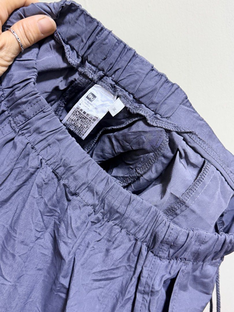 GU Parachute Cargo Pants Gray Size M (Category: Other Bottoms) located in Paete. Submitted by skydruemadison (Listing ID 1468193817, Image 3). Description: - Brand/Model: GU Parachute Cargo Pants - Color: Dark Gray - Size: M - Waist: Elastic waistband with drawstring closure - Pockets: Multiple utility pockets on the sides - Hems: Adjustable drawstring hems for customizable leg shape - Material: Lightweight nylon for ultimate comfort - Condition: