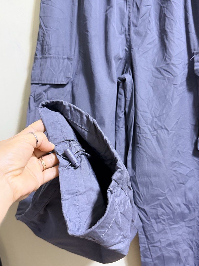 GU Parachute Cargo Pants Gray Size M (Category: Other Bottoms) located in Paete. Submitted by skydruemadison (Listing ID 1468193817, Image 2). Description: - Brand/Model: GU Parachute Cargo Pants - Color: Dark Gray - Size: M - Waist: Elastic waistband with drawstring closure - Pockets: Multiple utility pockets on the sides - Hems: Adjustable drawstring hems for customizable leg shape - Material: Lightweight nylon for ultimate comfort - Condition: