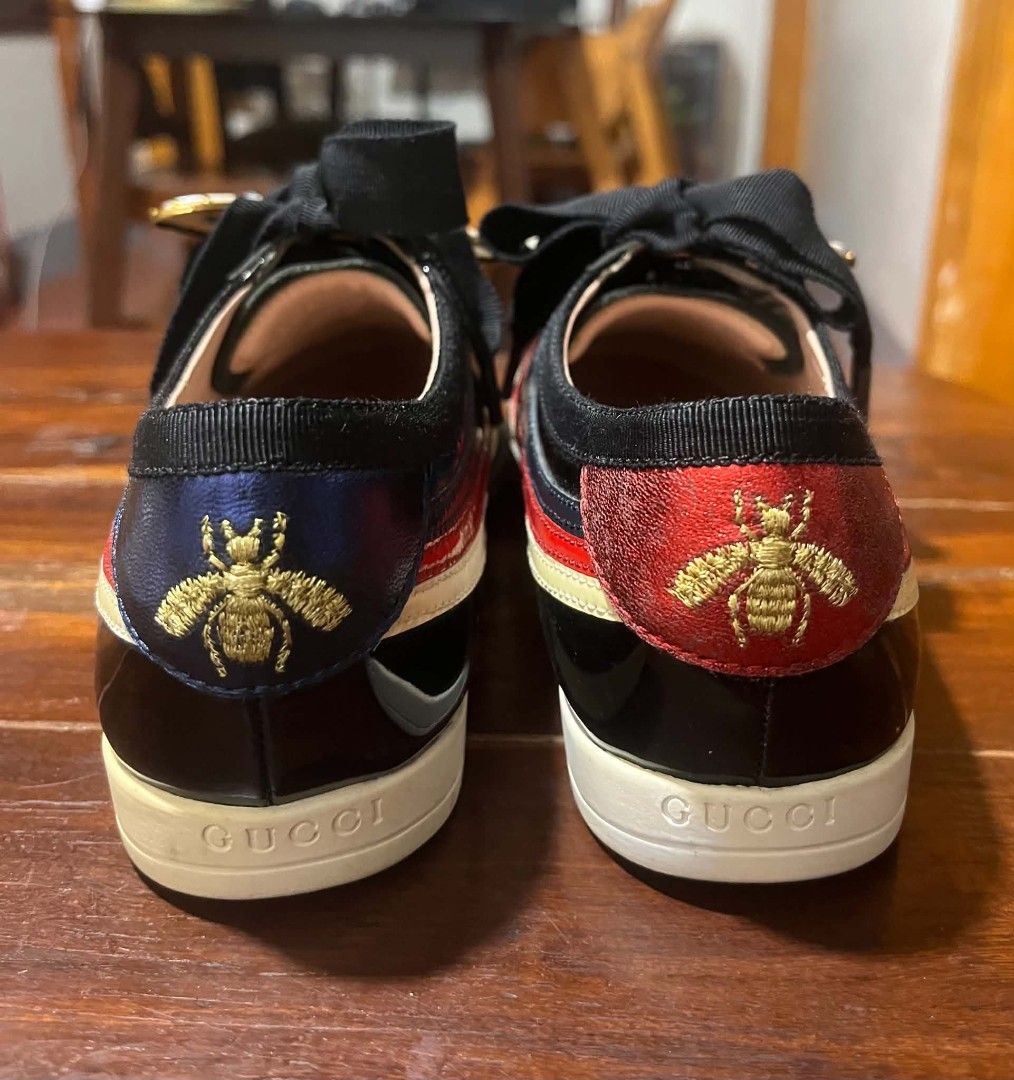 Gucci Falacer Butterfly Sneaker (Category: Sneakers & Footwear) located in Dasmarinas. Submitted by pitato.corner_2621 (Listing ID 1465921776, Image 3). Description: It is crafted from sleek black patent leather and accented with the brand's iconic retro-inspired color blocking on the side panels. Its standout feature is the detachable pearl and crystal butterfly charm clipped across the wide ribbon laces..