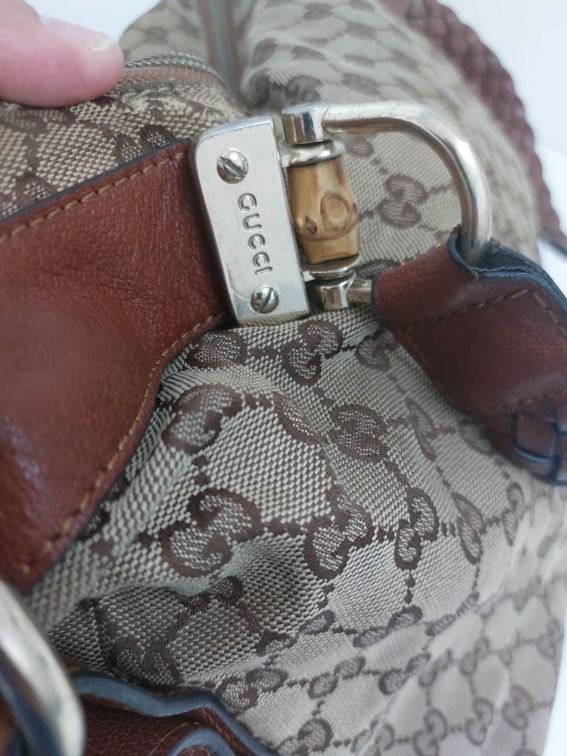 Gucci GG Canvas Monogram Bamboo Shoulder Bag (Category: Luxury Bags & Wallets) located in Valenzuela. Submitted by sv072724 (Listing ID 1468081616, Image 3). Description: - Authentic Gucci shoulder bag in classic brown GG monogram canvas - Features stylish brown leather trim and a comfortable braided leather handle - Iconic bamboo hardware details on the metal clasps - Secure double zipper closure with dual Gucci-engraved pulls - Roomy interior c