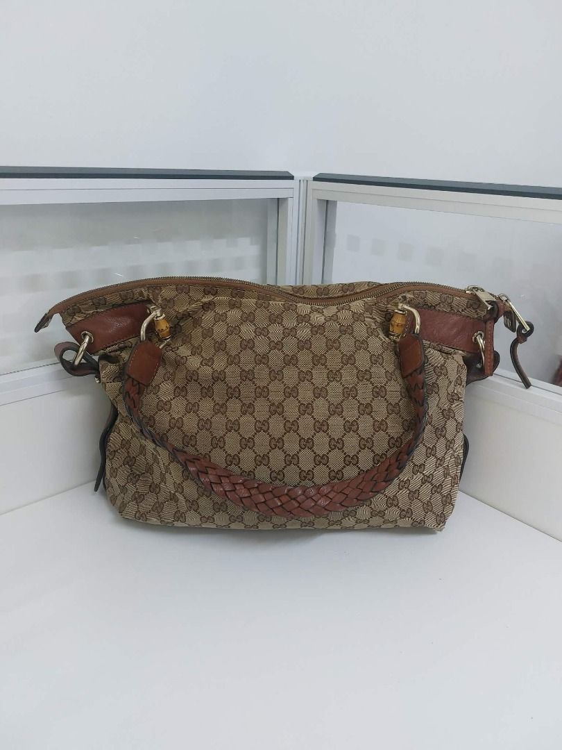 Gucci GG Canvas Monogram Bamboo Shoulder Bag (Category: Luxury Bags & Wallets) located in Valenzuela. Submitted by sv072724 (Listing ID 1468081616, Image 2). Description: - Authentic Gucci shoulder bag in classic brown GG monogram canvas - Features stylish brown leather trim and a comfortable braided leather handle - Iconic bamboo hardware details on the metal clasps - Secure double zipper closure with dual Gucci-engraved pulls - Roomy interior c