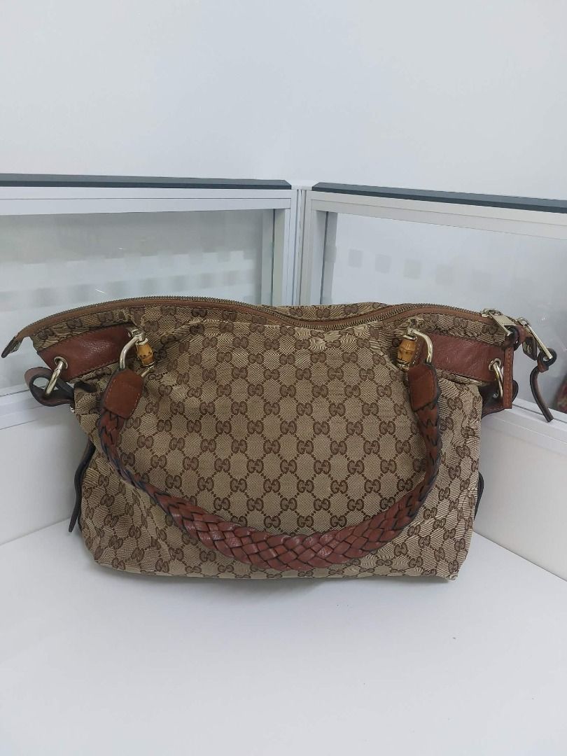 Gucci GG Canvas Monogram Bamboo Shoulder Bag (Category: Luxury Bags & Wallets) located in Valenzuela. Submitted by sv072724 (Listing ID 1468081616, Image 1). Description: - Authentic Gucci shoulder bag in classic brown GG monogram canvas - Features stylish brown leather trim and a comfortable braided leather handle - Iconic bamboo hardware details on the metal clasps - Secure double zipper closure with dual Gucci-engraved pulls - Roomy interior c