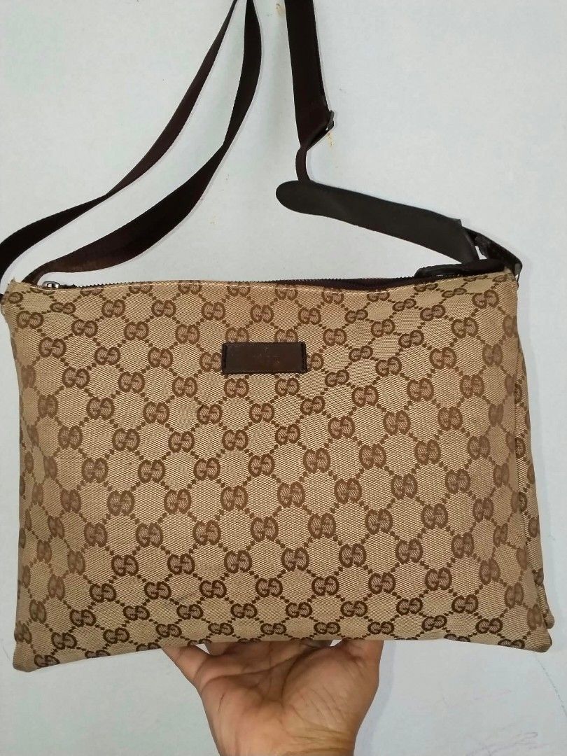 Gucci GG Monogram Canvas Bag (Category: Shoulder Bags) located in Manila. Submitted by bagelyascollection (Listing ID 1462613042, Image 1). Description: - Authentic Gucci canvas.bag - Classic GG monogram canvas - Gold-tone hardware - Iconic Gucci logo and cute ball charm - Interior zipper pocket - Made in Italy - Serial number visible in photos.