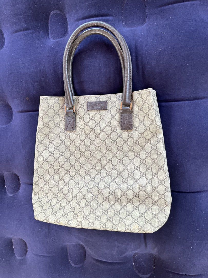 Gucci GG Monogram Canvas Tote Bag (Category: Luxury Bags & Wallets) located in Tacloban City. Submitted by luxbag_phhh (Listing ID 1468083375, Image 3). Description: - Gucci tote bag with iconic GG monogram canvas - Classic brown leather handles and trim - Spacious open-top design, perfect for daily essentials - Structured shape that holds its form well - Condition: Shows minor wear near the bottom corners and edges - Message us if you have any q