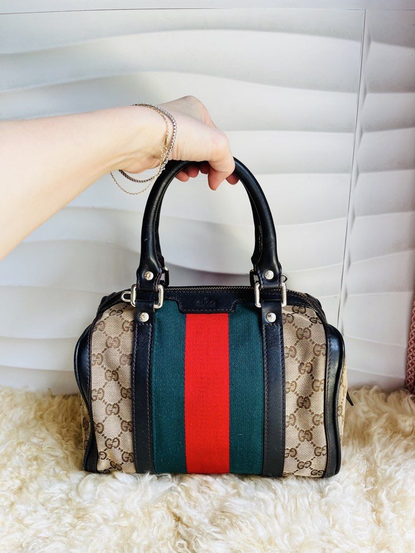 Gucci Monogram Web Boston Bag (Category: Luxury Bags & Wallets) located in Davao. Submitted by goodthingsph_ (Listing ID 1468076855, Image 1). Description: - Classic green and red web stripe with black leather trim - Dual top handles and secure top zip closure - Interior includes a zippered pocket and serial number (269876 4661) - Condition note: Beige interior lining has some staining/wear, and hardware has a worn finish - Perfect everyday luxur