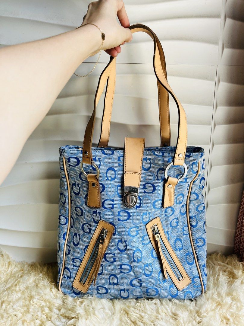 Guess Blue Monogram Shoulder Bag Tote (Category: Shoulder Bags) located in Davao. Submitted by goodthingsph_ (Listing ID 1468076274, Image 1). Description: - Brand: Guess - Style: Y2K shoulder bag / everyday tote - Material: Blue monogram canvas with tan leather trim - Closure: Front flap with push-lock - Pockets: Two diagonal exterior zip pockets, plus interior compartments and zip pocket - Interior: Vibrant blue satin lining - Origin: Made in C